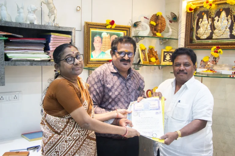 Property registration document handover between Anayaa Greenland team and happy plot buyers in office