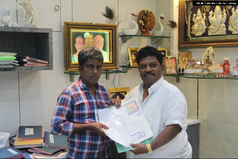 Property registration document handover between Anayaa Greenland team and happy plot buyers in office