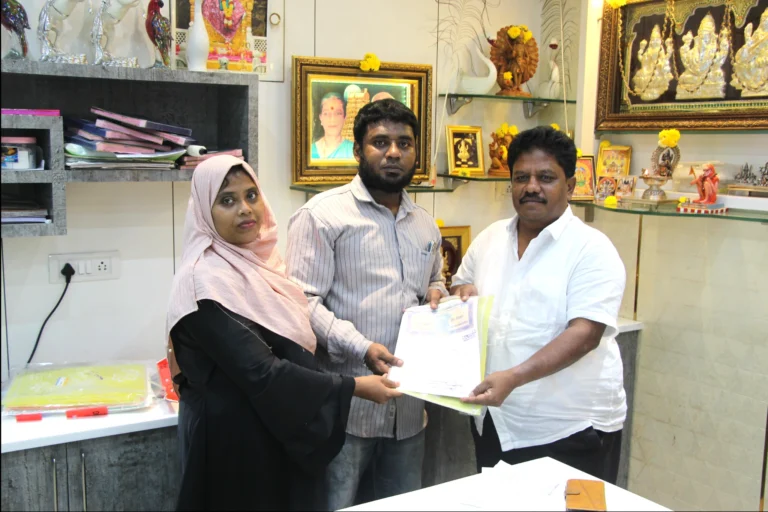 Property registration document handover between Anayaa Greenland team and happy plot buyers in office