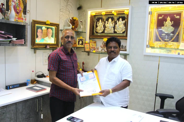 Property registration document handover between Anayaa Greenland team and happy plot buyers in office