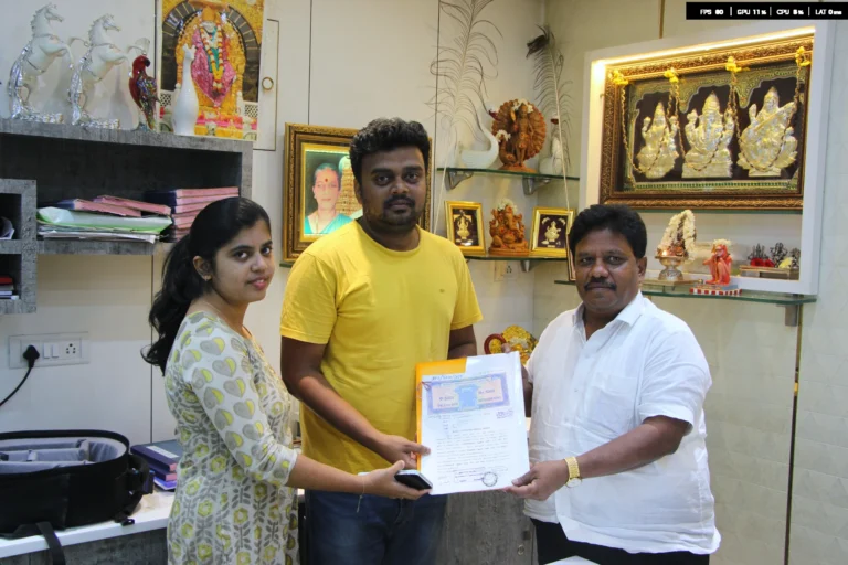 Property registration document handover between Anayaa Greenland team and happy plot buyers in office