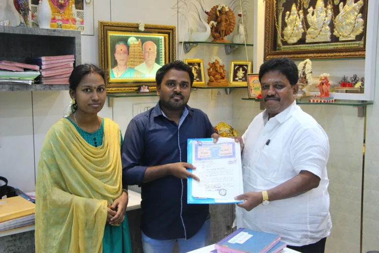 Property registration document handover between Anayaa Greenland team and happy plot buyers in office