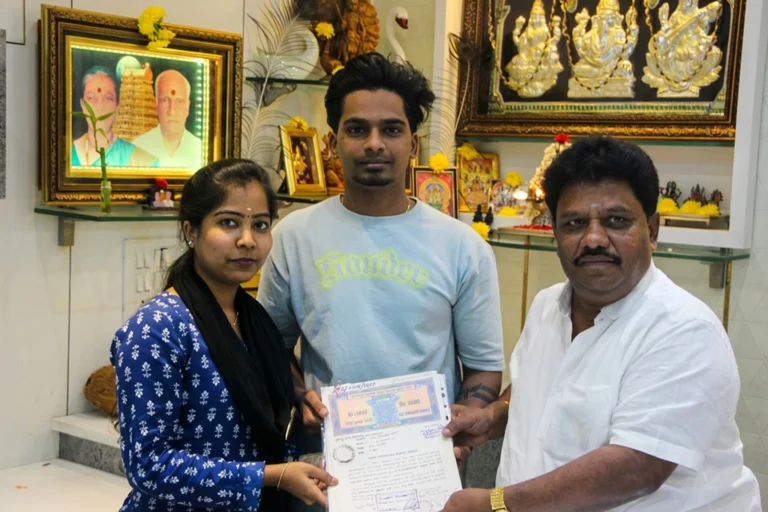 Property registration document handover between Anayaa Greenland team and happy plot buyers in office