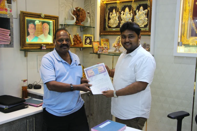 Property registration document handover between Anayaa Greenland team and happy plot buyers in office