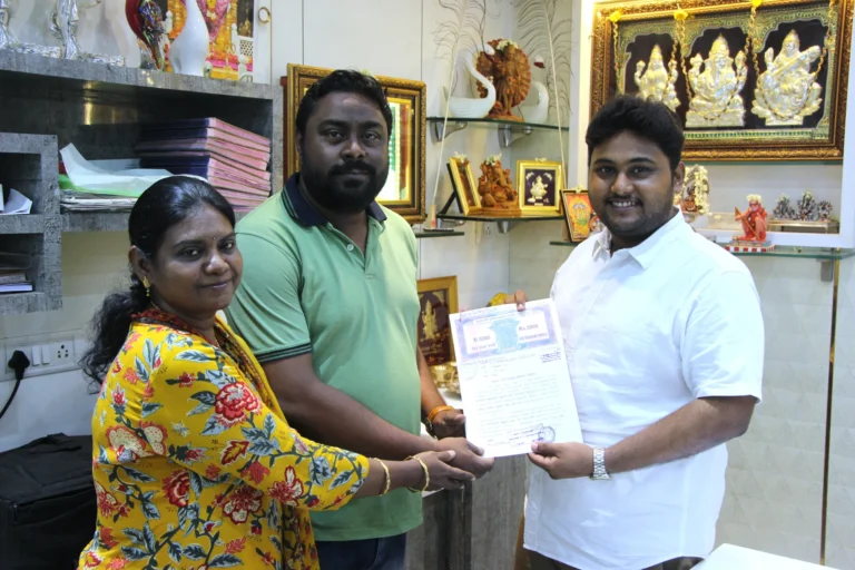 Property registration document handover between Anayaa Greenland team and happy plot buyers in office