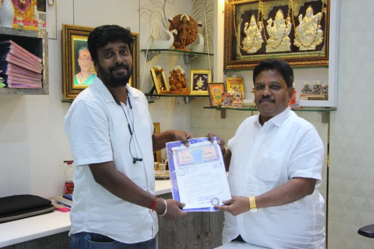 Property registration document handover between Anayaa Greenland team and happy plot buyers in office