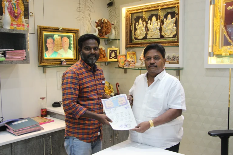 Property registration document handover between Anayaa Greenland team and happy plot buyers in office