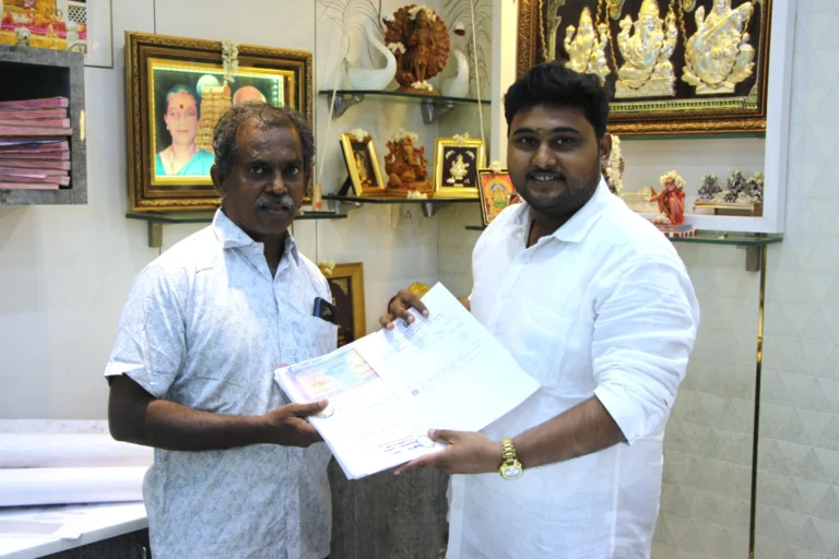 Property registration document handover between Anayaa Greenland team and happy plot buyers in office