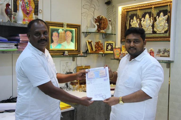 Property registration document handover between Anayaa Greenland team and happy plot buyers in office