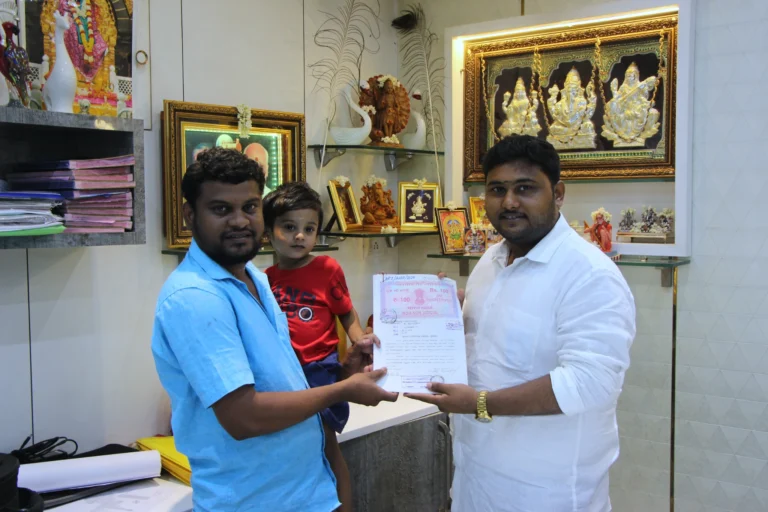 Property registration document handover between Anayaa Greenland team and happy plot buyers in office