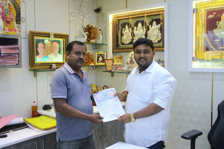 Property registration document handover between Anayaa Greenland team and happy plot buyers in office