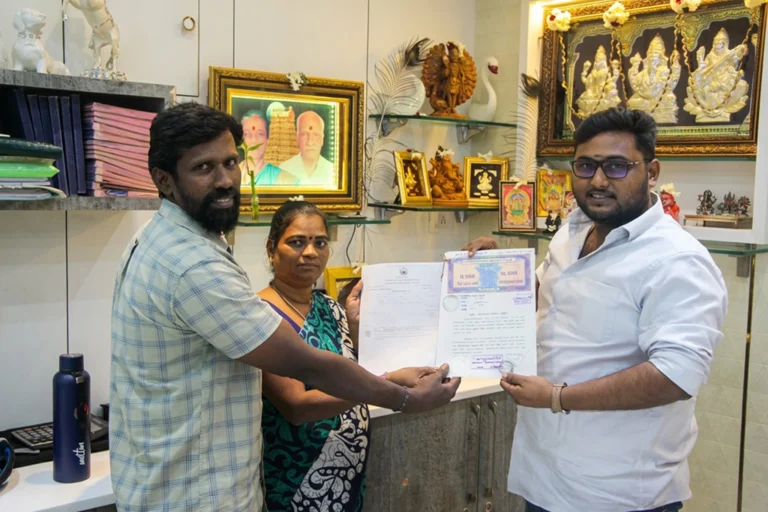 Property registration document handover between Anayaa Greenland team and happy plot buyers in office
