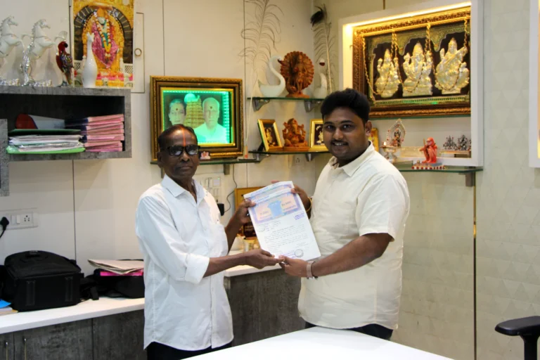 Property registration document handover between Anayaa Greenland team and happy plot buyers in office