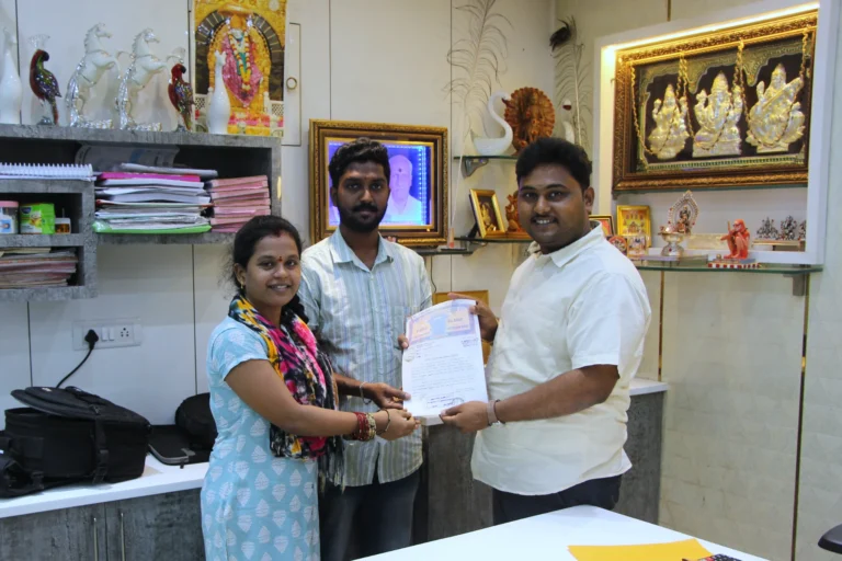Property registration document handover between Anayaa Greenland team and happy plot buyers in office