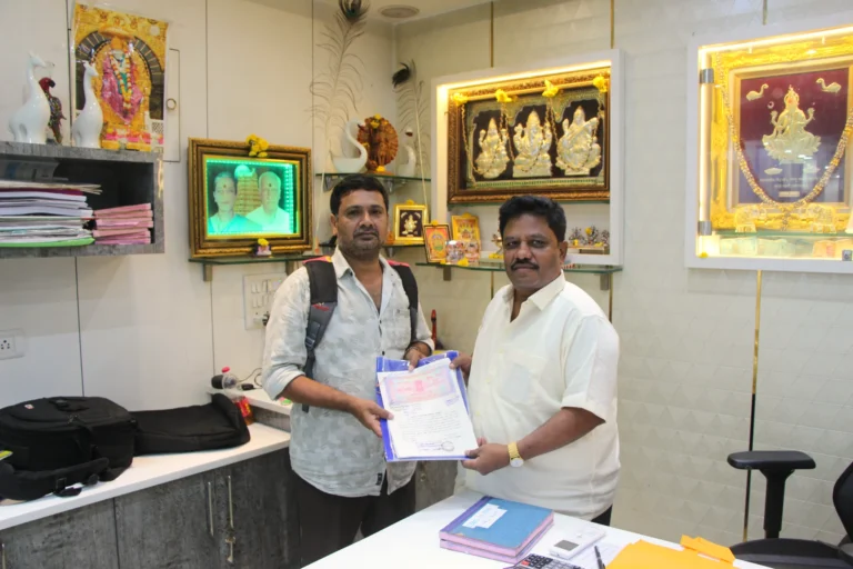 Property registration document handover between Anayaa Greenland team and happy plot buyers in office