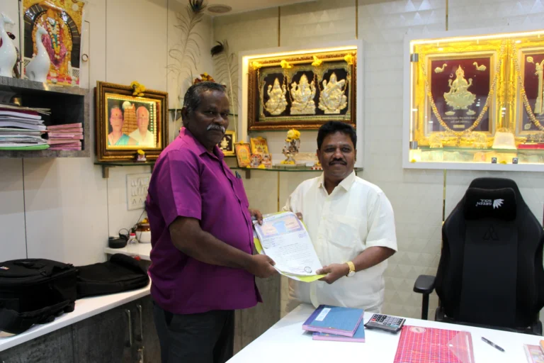 Property registration document handover between Anayaa Greenland team and happy plot buyers in office