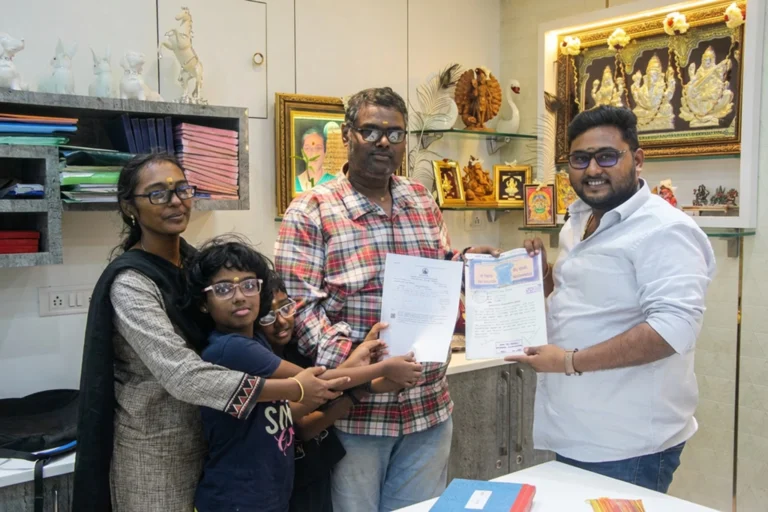Property registration document handover between Anayaa Greenland team and happy plot buyers in office