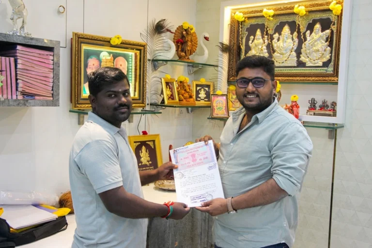 Property registration document handover between Anayaa Greenland team and happy plot buyers in office